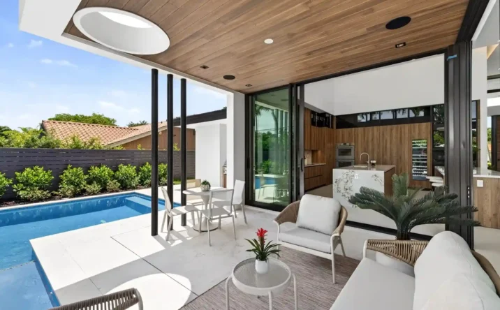 Modern covered patio with wood ceiling, outdoor seating, and seamless indoor-outdoor living.