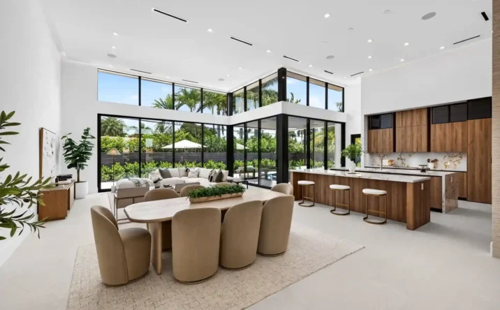 Bright open kitchen and dining area with floor-to-ceiling windows and modern finishes.
