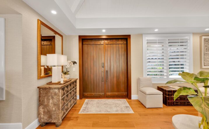 Residential entryway with custom wood door by CKA Construction