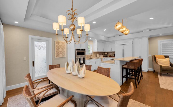 Elegant dining space with chandelier lighting by CKA Construction