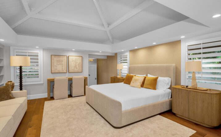 Spacious living room with coffered ceiling by CKA Construction