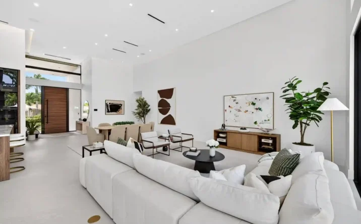 Contemporary living room with built-in cabinetry, neutral décor, and abundant natural lighting.