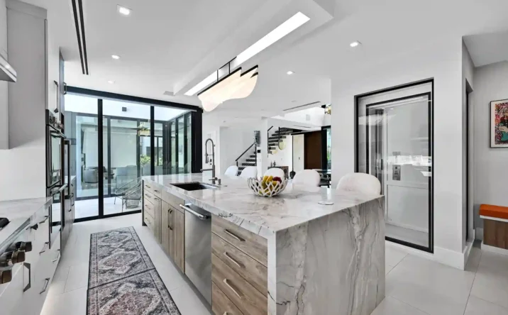 Spacious modern great room featuring expansive windows, high ceilings, and open floor plan.