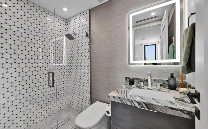 Spa-inspired bathroom with freestanding soaking tub, glass shower, and modern tile finishes.