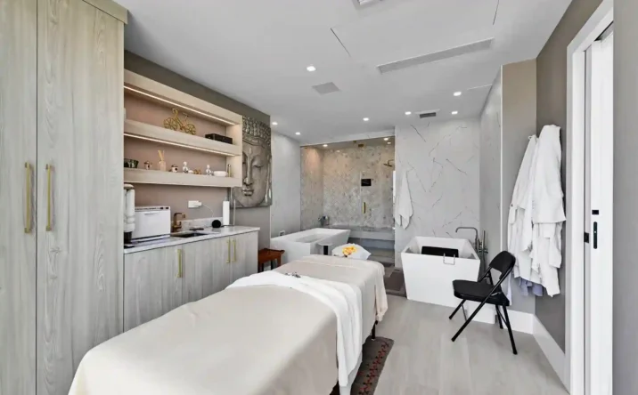 Modern open-concept living area with custom built-in shelving and minimalist interior design.
