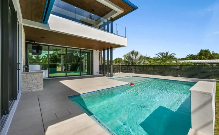 Modern waterfront home exterior with clean architectural lines and private backyard.
